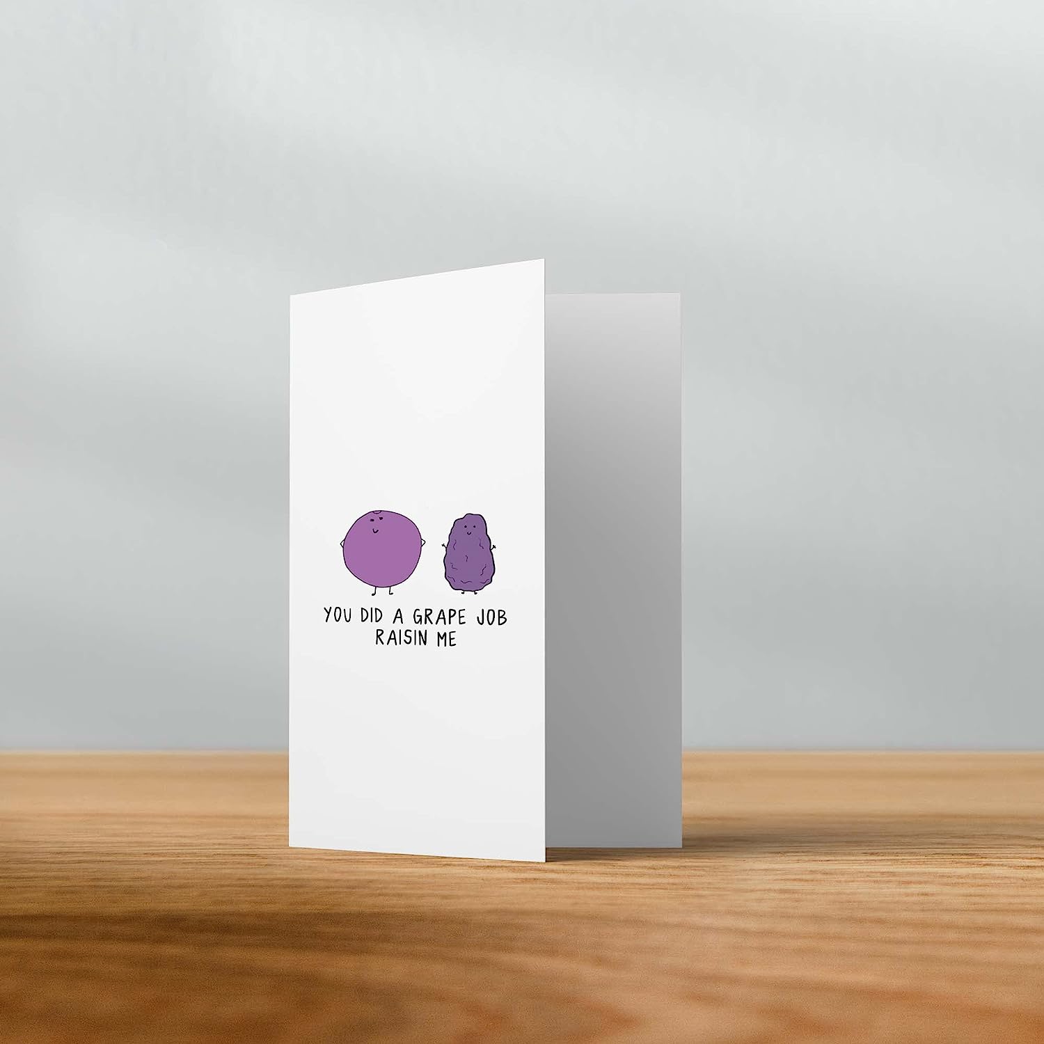 A Grape Job Raisin Me Card from rockdoodles adorned with a single purple dot on it.