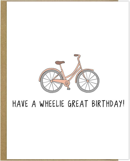 A pink bicycle with black text, rockdoodles Wheelie Great Birthday Card.