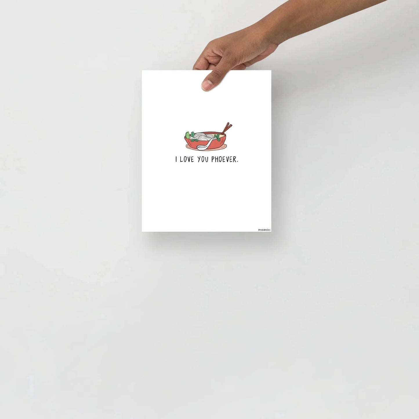 A hand holding a card saying "i'm hungry" framed on renewable forests matte paper, featuring the Love You Phoever Print by rockdoodles.