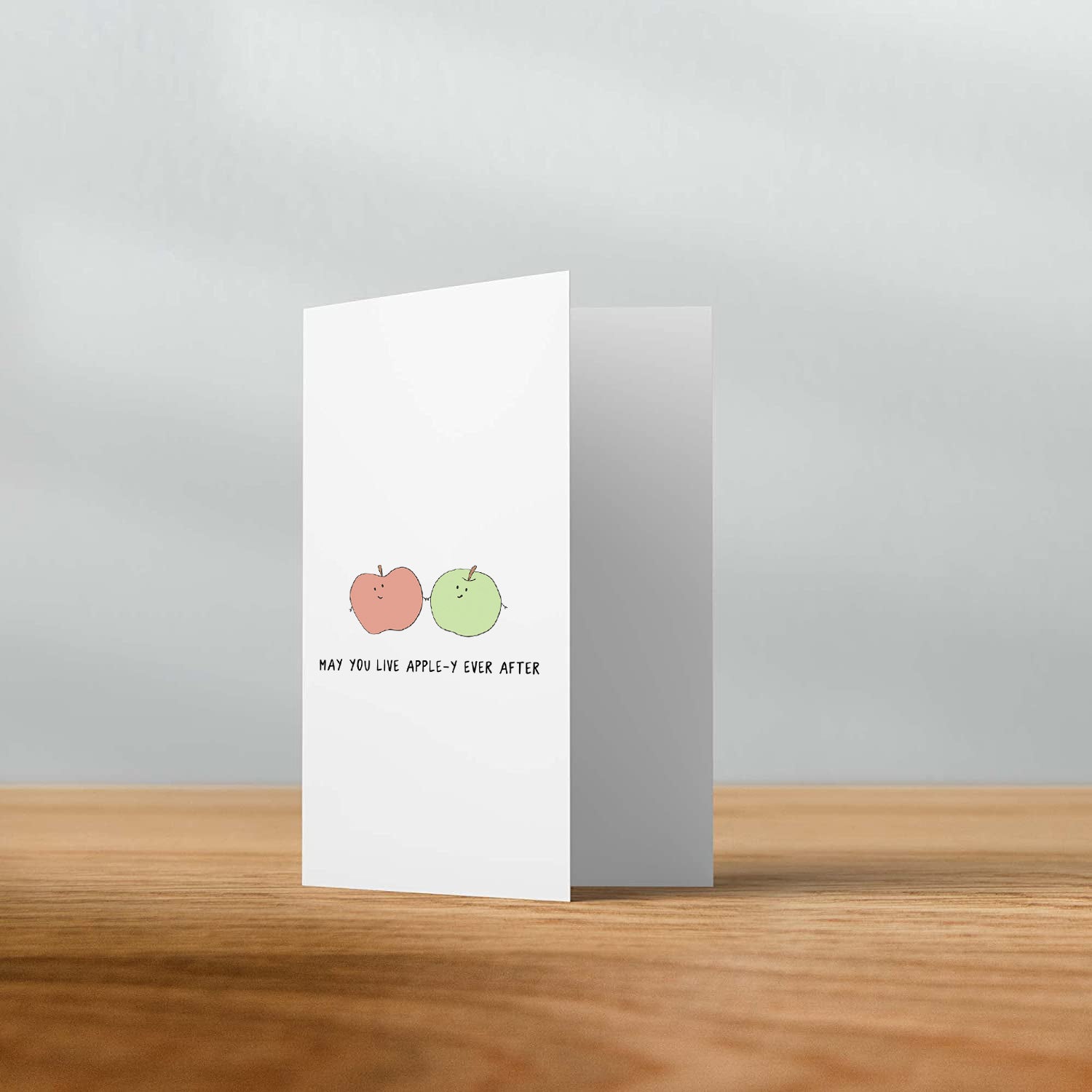 A greeting card featuring two Apple-y Ever After Cards by rockdoodles, enclosed in a natural envelope.