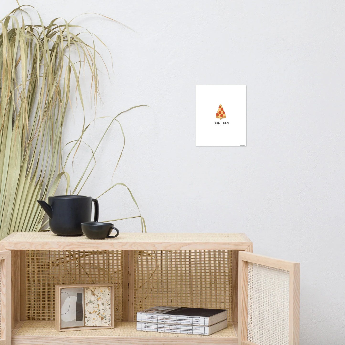 A living room with a coffee table and a rockdoodles Carpe Diem Print on the wall.