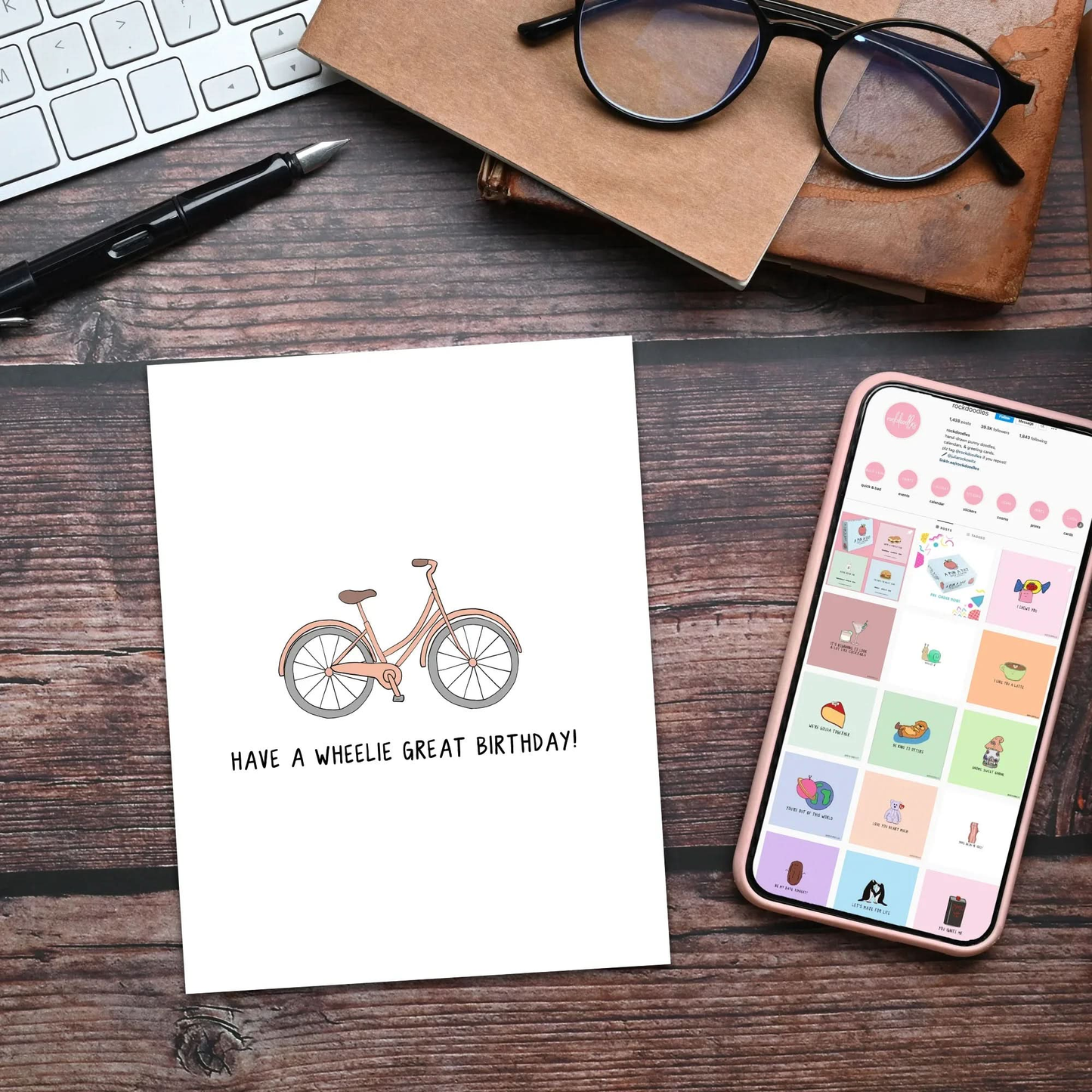 A rockdoodles Wheelie Great Birthday card measures 4.25 in. x 5.5 in, featuring a bicycle on it next to a phone and glasses.