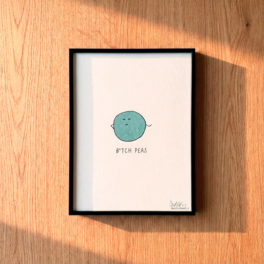 Add whimsy to your space with rockdoodles’ Limited Edition Signed Prints: a framed illustration of a single green pea labeled “B*TCH PEAS”—the perfect funny pun gift for any art lover!.
