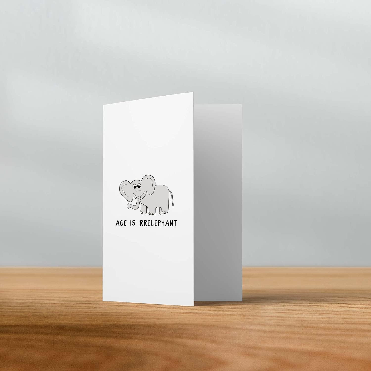 A rockdoodles Age Is Irrelephant Card featuring an elephant design, perfect for any age, with a natural envelope.
