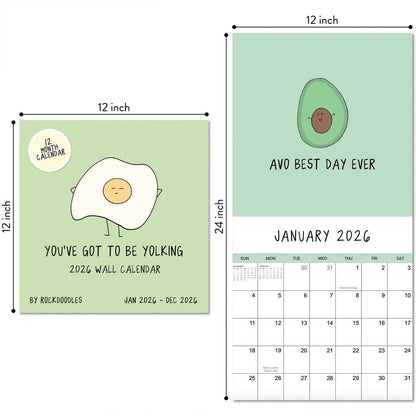 The rockdoodles 2026 Wall Calendar "You've Got To Be Yolking" features a cartoon egg cover and fun art like an avocado with “Avo Best Day Ever” for January, plus a useful monthly grid.