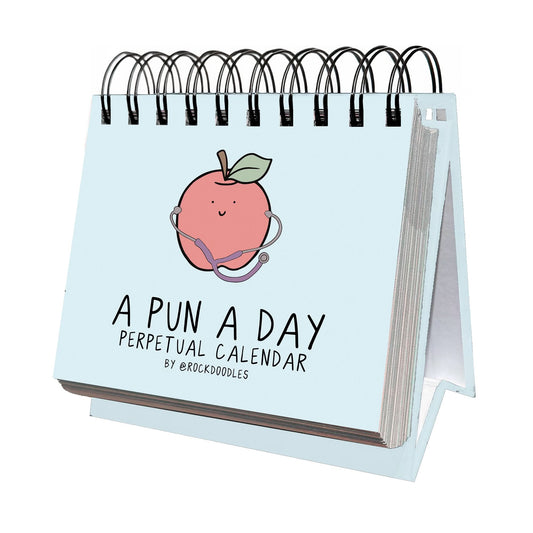 The rockdoodles "A Pun A Day Perpetual Calendar" is a spiral-bound desk calendar with a cover illustration of a smiling peach wearing a stethoscope—perfect for daily pun lovers.