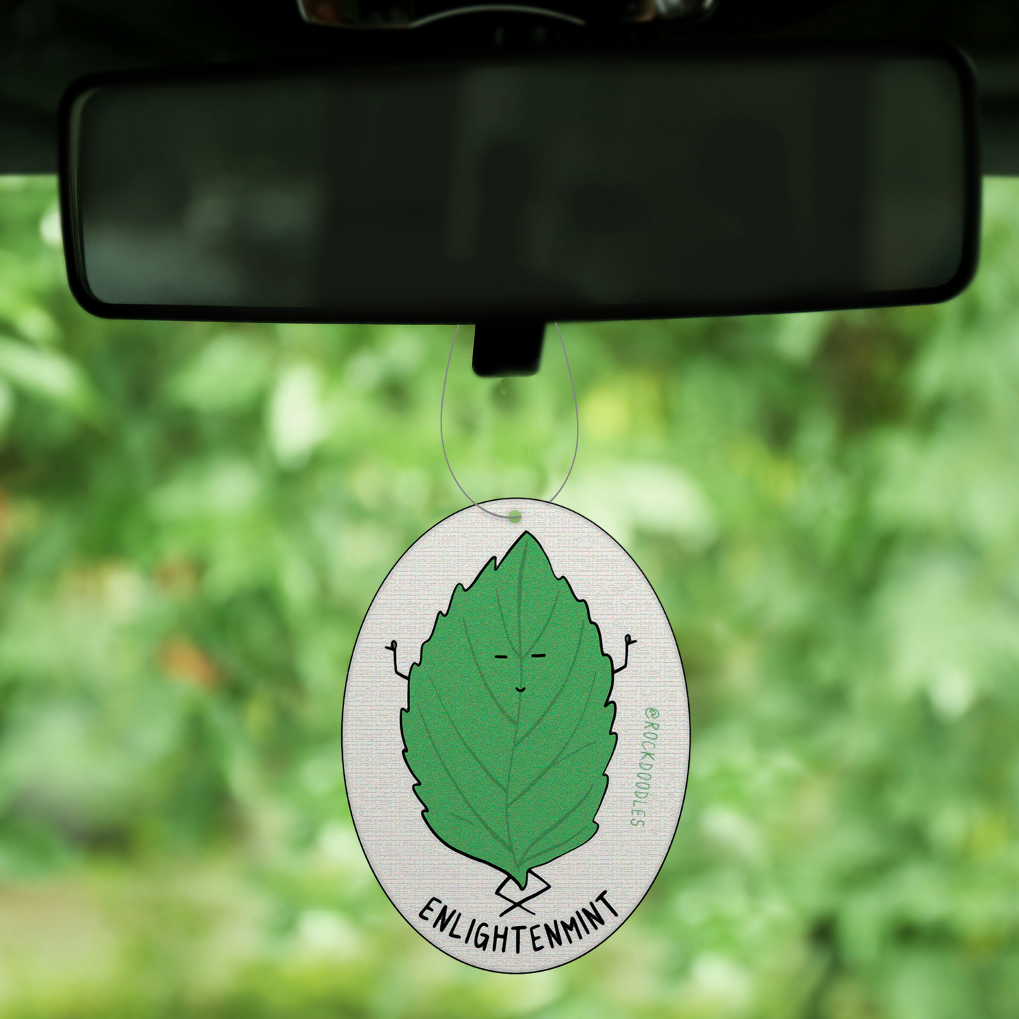 A 2-pack car air freshener with a leaf on it, featuring a Fresh Peppermint Scent.
Product: rockdoodles Enlightenmint (2-Pack) Punny Air Freshener - Fresh Peppermint Scent.