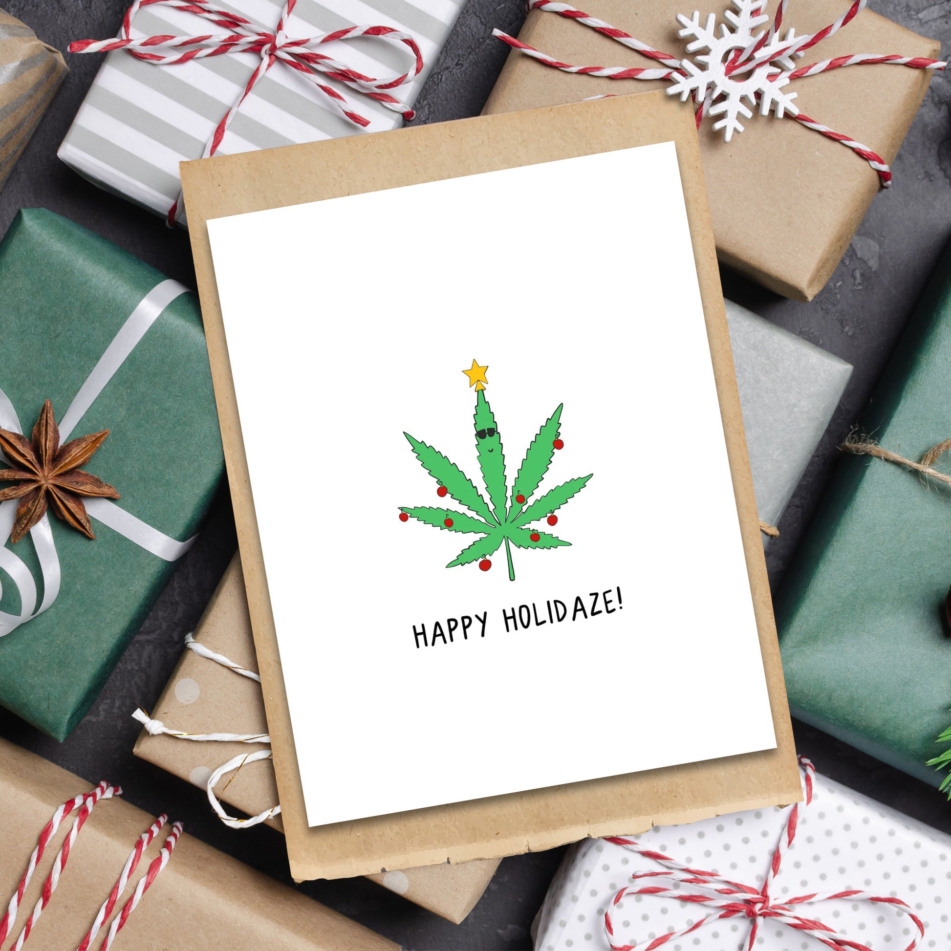 A rockdoodles Holidaze card with a marijuana leaf on it, enclosed in a natural envelope.