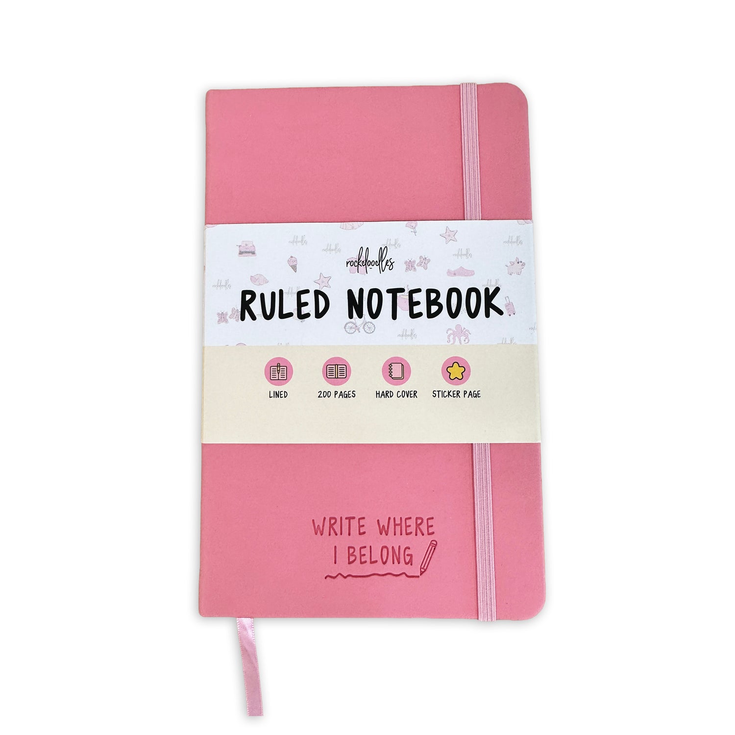 The Rockdoodles Notebook by rockdoodles is a pink hardcover journal with college-ruled pages, elastic band, ribbon bookmark, “Ruled Notebook” and “Write Where I Belong” labels, 200 pages, and a sticker page for personal style.
