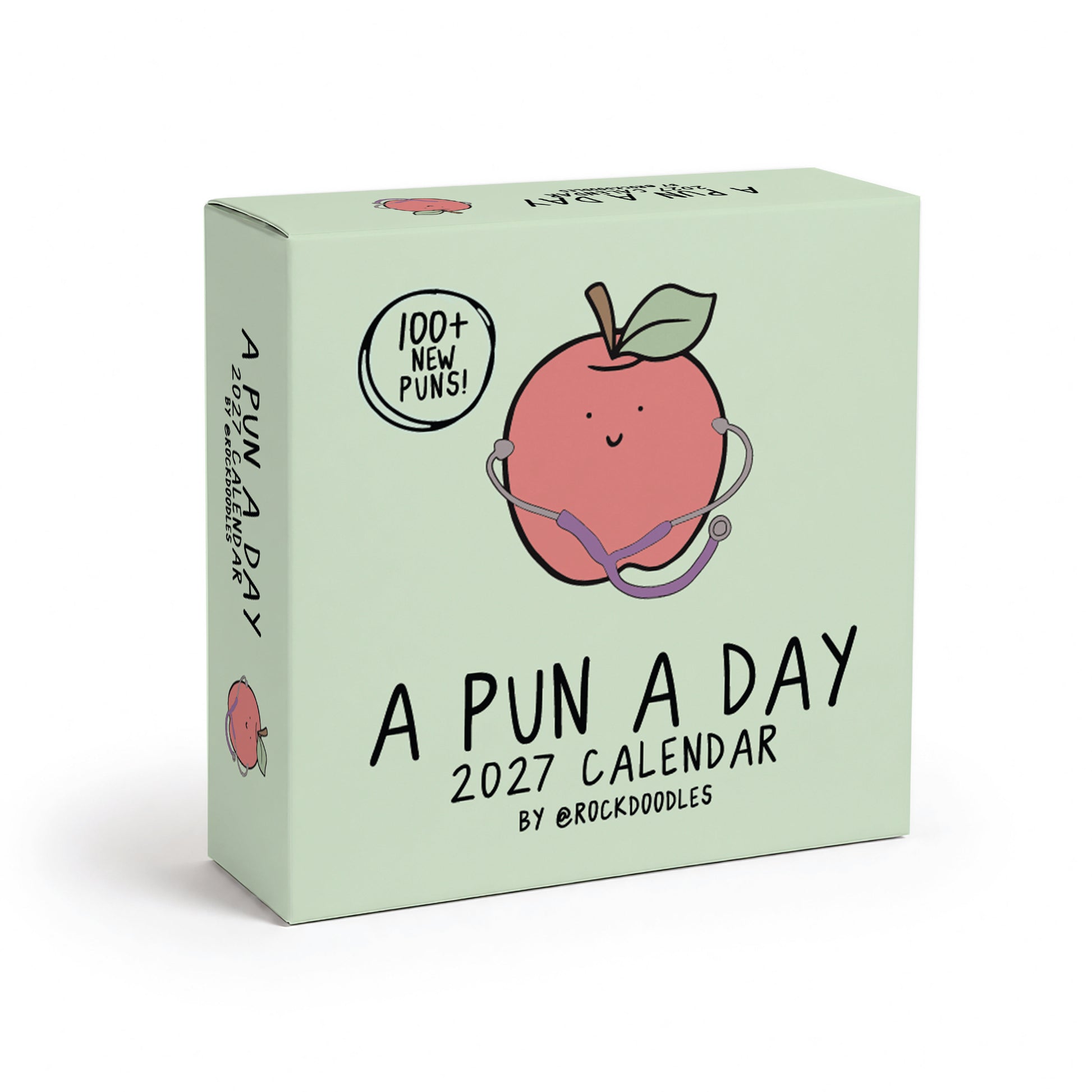 Light green box for the 2027 A Pun A Day Desktop Calendar by rockdoodles, featuring a cartoon apple with a stethoscope and "100+ new puns!" on the front. This plastic-free calendar is filled with pun-packed illustrations to brighten your day, every day.