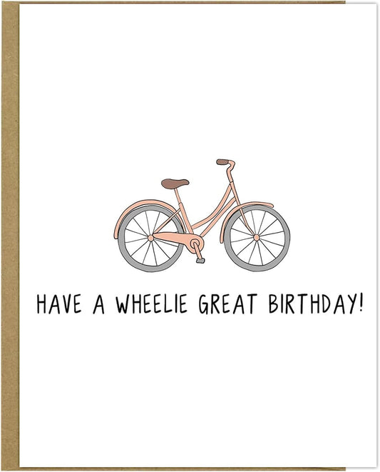 A pink bicycle with black text, rockdoodles Wheelie Great Birthday Card.