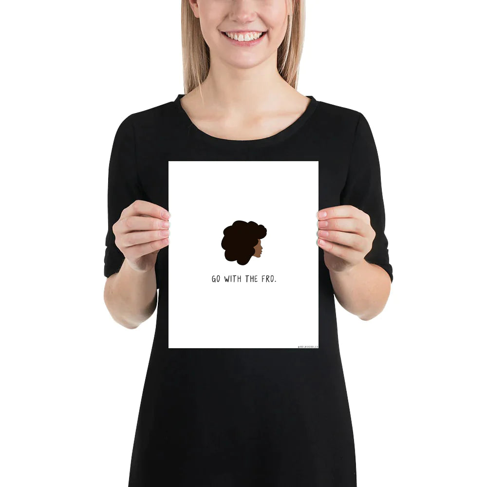 A woman holding a rockdoodles Go With The Fro Print.