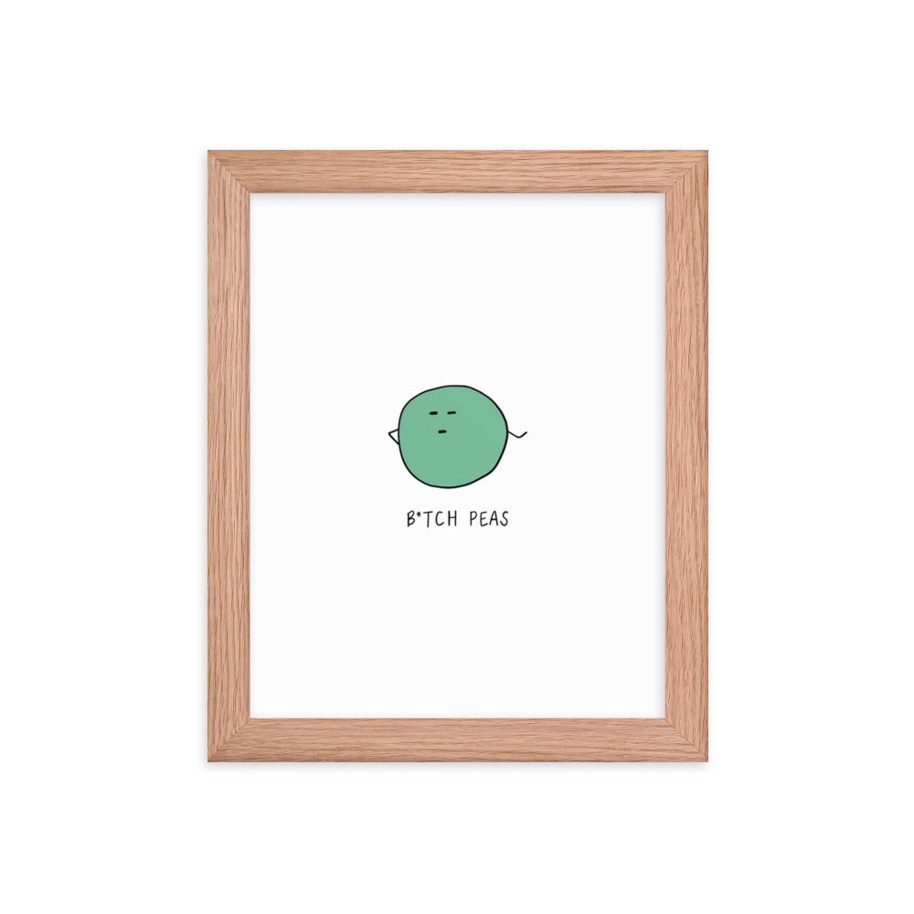 This framed B**** Peas Print by rockdoodles features a green sphere with the word eat, beautifully printed on matte paper and encased in a wood frame.