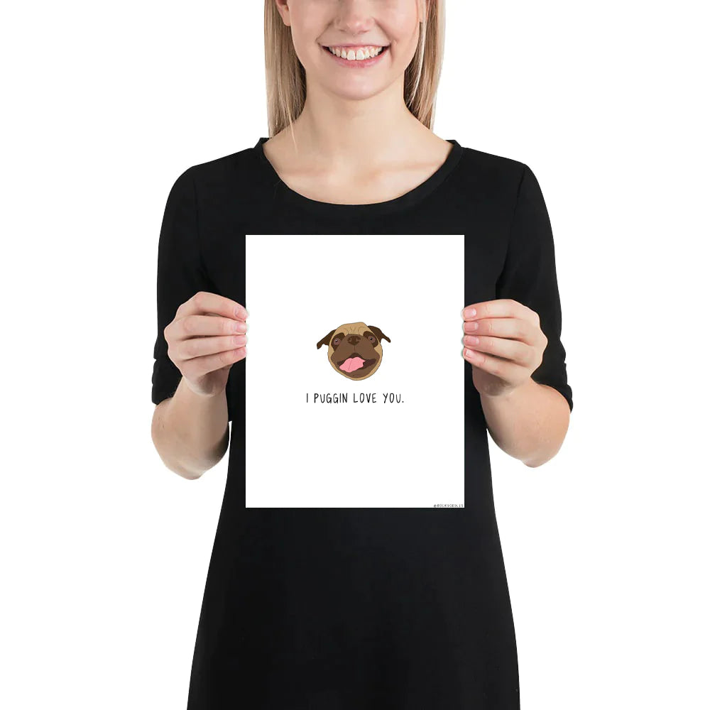 A woman holding up a rockdoodles Puggin Love You Print.