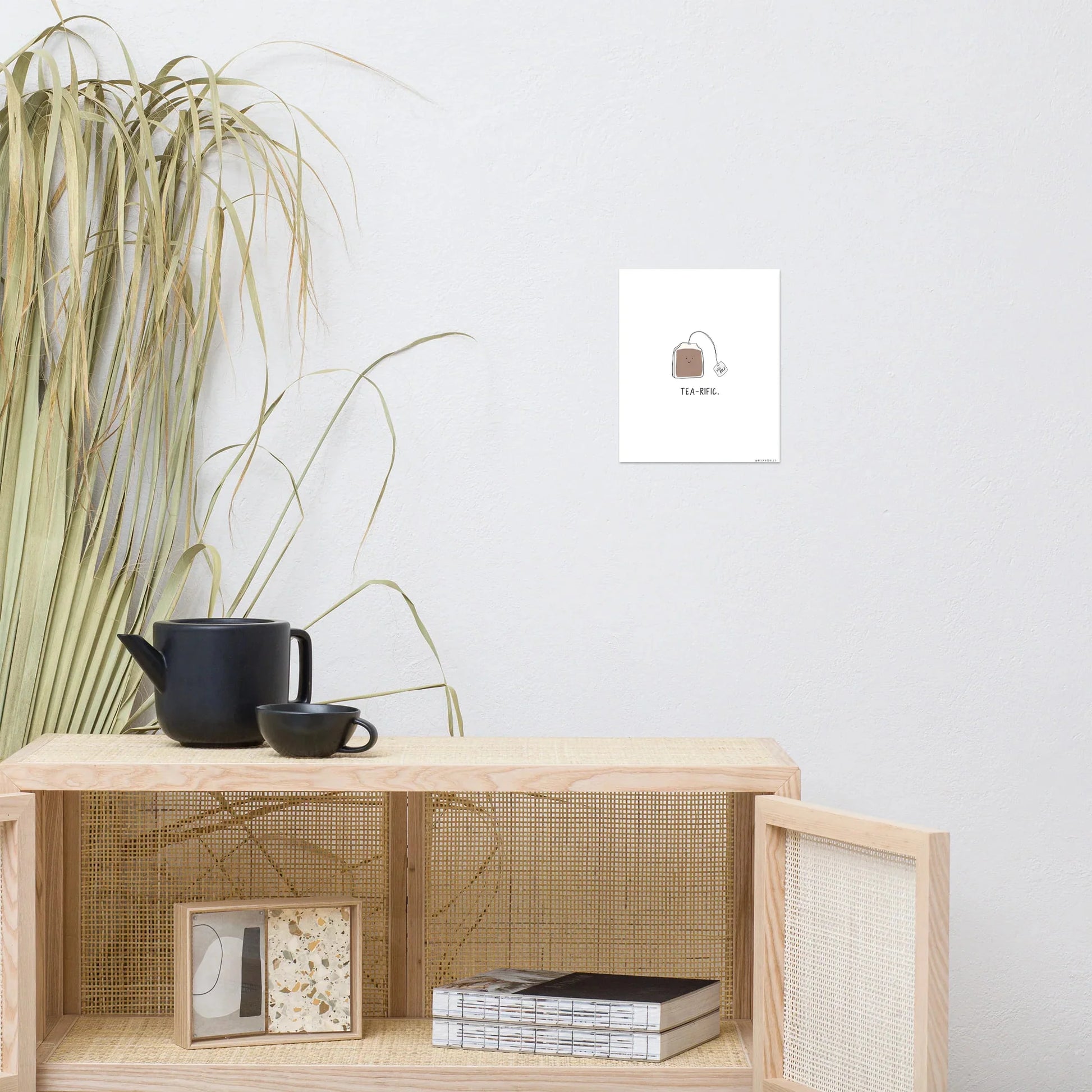 A shelf with a rockdoodles Tea-rific Print on the wall.